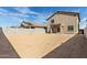 Large, flat backyard with a covered patio, block wall fencing, and space for entertaining at 8552 N 170Th Ln, Waddell, AZ 85355