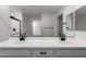 Bathroom features double sinks, a large mirror, and a shower with black fixtures for a modern look at 8552 N 170Th Ln, Waddell, AZ 85355