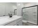 Modern bathroom featuring walk-in shower, vanity, and fixtures in black and white at 8552 N 170Th Ln, Waddell, AZ 85355