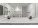 Bathroom showcases a double sink vanity and an expansive mirror, enhancing the bright and modern aesthetic at 8552 N 170Th Ln, Waddell, AZ 85355