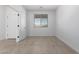 Bright, empty bedroom with neutral tile flooring, white walls, and ample natural light at 8552 N 170Th Ln, Waddell, AZ 85355