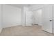 Bright, empty bedroom with neutral tile flooring, white walls, and ample natural light at 8552 N 170Th Ln, Waddell, AZ 85355