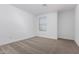 A bedroom features a large window, allowing natural light to fill the space, complementing neutral carpet and walls at 8552 N 170Th Ln, Waddell, AZ 85355
