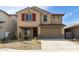 Two-story home featuring red shutters and a two car garage with desert landscaping at 8552 N 170Th Ln, Waddell, AZ 85355