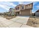 Two-story home featuring red shutters and a two car garage with desert landscaping at 8552 N 170Th Ln, Waddell, AZ 85355