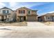 Two-story home featuring red shutters and a two car garage with desert landscaping at 8552 N 170Th Ln, Waddell, AZ 85355