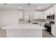 Modern kitchen with stainless steel appliances, white cabinets and quartz countertops at 8552 N 170Th Ln, Waddell, AZ 85355