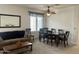 Open-concept living room and dining area with neutral decor, perfect for entertaining guests or Gathering at 1095 W Desert Valley Dr, San Tan Valley, AZ 85143