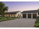 Charming single-story home featuring a three-car garage, brick driveway, and well-manicured landscaping at 88 N Country Club Dr, Phoenix, AZ 85014