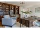 Bright home office features custom built-in shelves, hardwood floors, and a large desk at 88 N Country Club Dr, Phoenix, AZ 85014