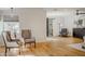 Bright and airy living room features hardwood floors, two chairs, with natural light at 88 N Country Club Dr, Phoenix, AZ 85014