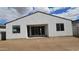 Exterior shot showcasing the home's backyard, white stucco, and sliding glass door access at 37600 N Cowboy Ln, San Tan Valley, AZ 85140