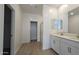 Bright bathroom featuring a double vanity, white cabinets, and a separate shower room at 37600 N Cowboy Ln, San Tan Valley, AZ 85140