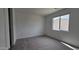 A carpeted bedroom featuring a window providing natural light and a view of the neighborhood at 37600 N Cowboy Ln, San Tan Valley, AZ 85140