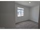 A carpeted bedroom featuring a window providing natural light and a view of the neighborhood at 37600 N Cowboy Ln, San Tan Valley, AZ 85140