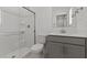 Clean bathroom featuring a shower with glass door, a toilet, and vanity with a gray cabinet at 7449 S 75Th Dr, Laveen, AZ 85339