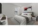 Bright bedroom featuring a comfortable bed, stylish decor, and natural light from a window at 7449 S 75Th Dr, Laveen, AZ 85339