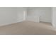 Large carpeted room with white walls, perfect for a bedroom or living area in a modern home at 7449 S 75Th Dr, Laveen, AZ 85339