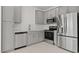Modern kitchen featuring gray cabinets, stainless steel appliances, and white subway tile backsplash at 7449 S 75Th Dr, Laveen, AZ 85339