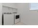 Laundry room with a washer and dryer set and shelving for storage at 7449 S 75Th Dr, Laveen, AZ 85339