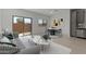 Bright living space featuring modern decor, a dining area, and a sliding glass door at 7449 S 75Th Dr, Laveen, AZ 85339