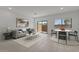 Inviting living space with a sofa, dining area, and sliding glass door leading outside at 7449 S 75Th Dr, Laveen, AZ 85339