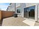 Gravel patio and sliding door in the backyard provide an outdoor space at 7449 S 75Th Dr, Laveen, AZ 85339