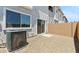 View of patio with gravel and building with an air conditioner at 7449 S 75Th Dr, Laveen, AZ 85339