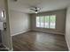 This is a bedroom with hardwood floors and a window with blinds and ceiling fan at 15075 W Amelia Dr, Goodyear, AZ 85395