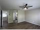 Bedroom with hardwood floors, ceiling fan, and neutral colored walls at 15075 W Amelia Dr, Goodyear, AZ 85395