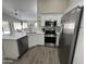 Bright kitchen with white cabinets, stainless steel appliances, and subway tile backsplash at 15075 W Amelia Dr, Goodyear, AZ 85395