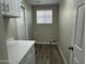 Laundry room features tile floor, a window, and white counter tops at 15075 W Amelia Dr, Goodyear, AZ 85395