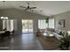 Open-concept living room featuring a dining area, comfortable seating and a sliding glass door at 15075 W Amelia Dr, Goodyear, AZ 85395