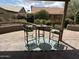 The covered patio features two chairs, a table, and a rug at 15075 W Amelia Dr, Goodyear, AZ 85395