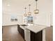 Modern kitchen with island, stainless steel appliances, and dark cabinetry at 17744 W Coolidge St, Goodyear, AZ 85395