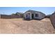 Large backyard features an ample space, enclosed by a block fence, offering privacy and potential at 40010 W Bravo Dr, Maricopa, AZ 85138