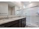 Modern bathroom features granite countertop with double sinks and glass-enclosed shower at 40010 W Bravo Dr, Maricopa, AZ 85138