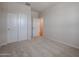 Bedroom with neutral carpet, closet, and door leading to hallway at 40010 W Bravo Dr, Maricopa, AZ 85138