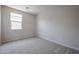 Carpeted bedroom with a bright window offering natural light at 40010 W Bravo Dr, Maricopa, AZ 85138