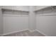 Walk-in closet features carpeted floors, built-in shelves, and ample space at 40010 W Bravo Dr, Maricopa, AZ 85138
