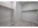 Spacious walk-in closet features carpeted floors, built-in shelves, and ample space at 40010 W Bravo Dr, Maricopa, AZ 85138