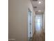 Bright hallway showcasing wood-look tile flooring and neutral wall tones at 40010 W Bravo Dr, Maricopa, AZ 85138