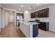 Modern kitchen with dark cabinets, stainless steel appliances, and granite countertops at 40010 W Bravo Dr, Maricopa, AZ 85138