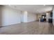Open living space with wood-look tile flooring, ample natural light, and modern finishes at 40010 W Bravo Dr, Maricopa, AZ 85138