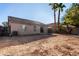 Sunny backyard with gravel and view of neighboring house at 574 W Kingman Dr, Casa Grande, AZ 85122