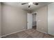 Spacious bedroom with door to hallway and ceiling fan at 574 W Kingman Dr, Casa Grande, AZ 85122