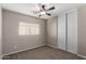 Well-lit bedroom featuring a ceiling fan and sliding door closet at 574 W Kingman Dr, Casa Grande, AZ 85122