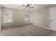 Well-lit bedroom with ceiling fan and neutral carpeting at 574 W Kingman Dr, Casa Grande, AZ 85122