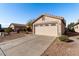 House exterior featuring a two-car garage and desert landscaping at 574 W Kingman Dr, Casa Grande, AZ 85122