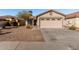 Single-story house with a two-car garage and desert landscaping at 574 W Kingman Dr, Casa Grande, AZ 85122